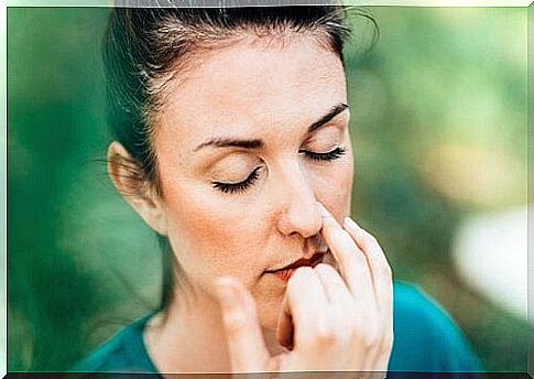 Woman with closed eyes practices alternating breathing