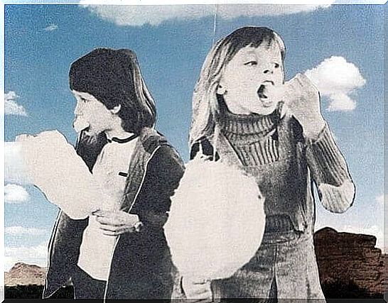 Two children eat cotton candy