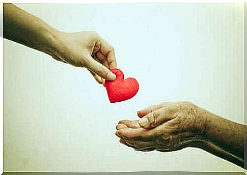 about prejudice - hand puts a heart in another hand