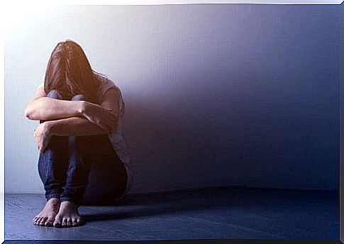 Woman with Endogenous Depression is sitting on the floor