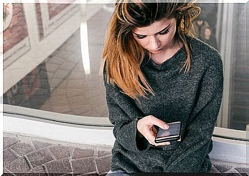 Sad woman waiting for a phone call symptomatic of anxiety and stress while looking for a job