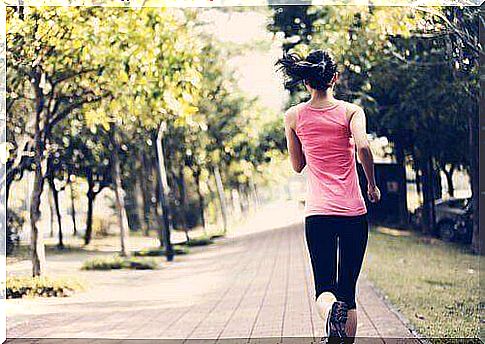 Woman jogs on a path.