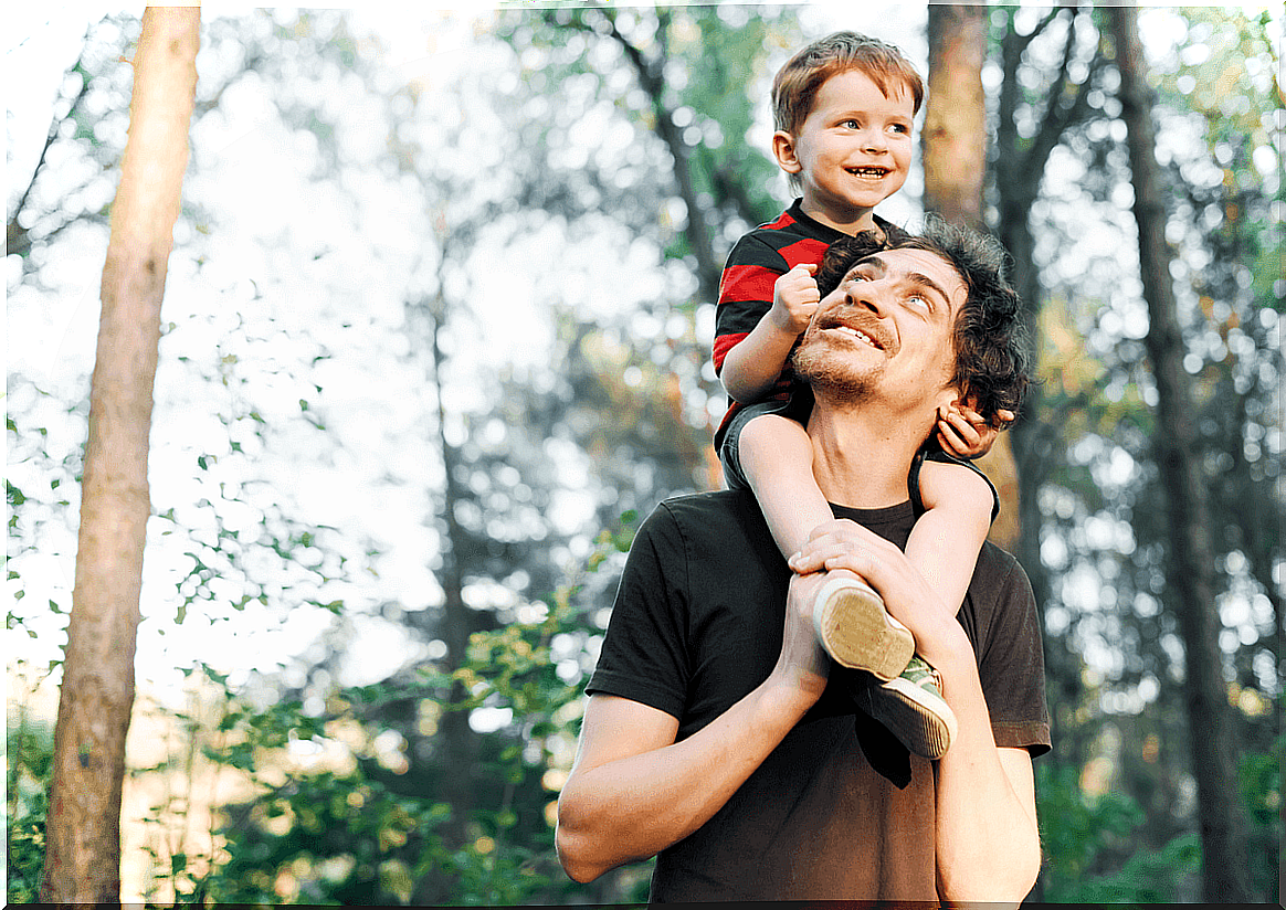 Father with his son on his shoulders demonstrating how to raise "good" children