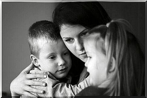 Mother hugs children