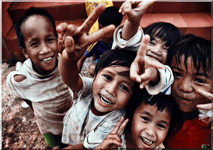 Orphans laugh happily at the camera