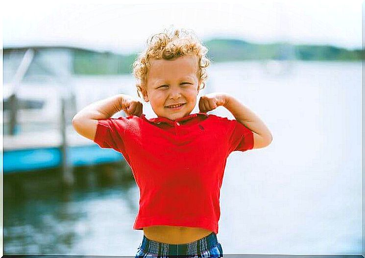 Little boy proudly shows his biceps