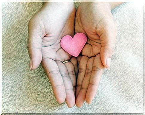 Fabric heart in the hands of a woman