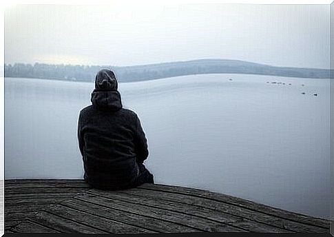 A person is sitting on a boat dock and is worried.  Use neuroplasticity to improve mood.