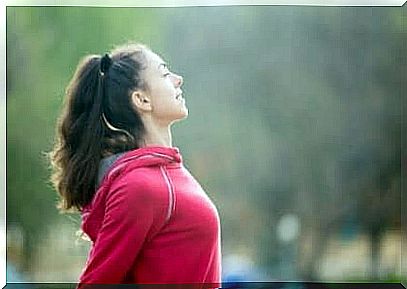 A woman stretching outside before exercising.