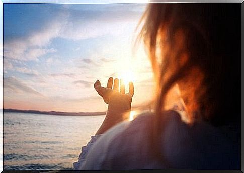 Woman on the beach at sunset