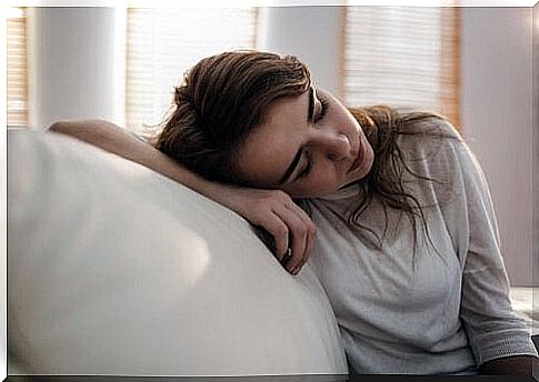 Depressed woman is sleeping on the sofa