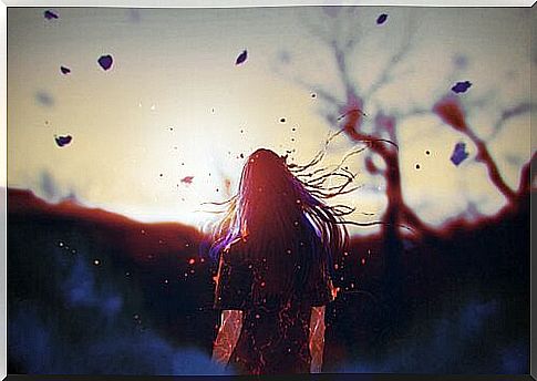 Woman with blowing hair in the autumn forest