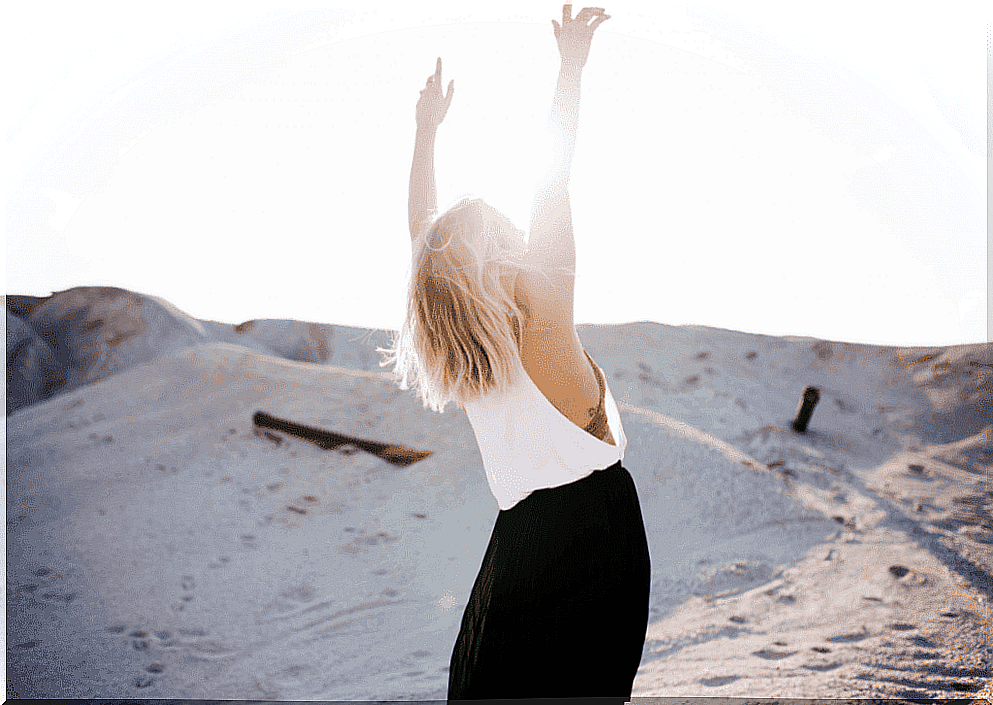 Woman stretches her arms up